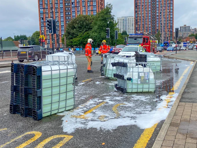 Several overturned containers leaking onto the roadway