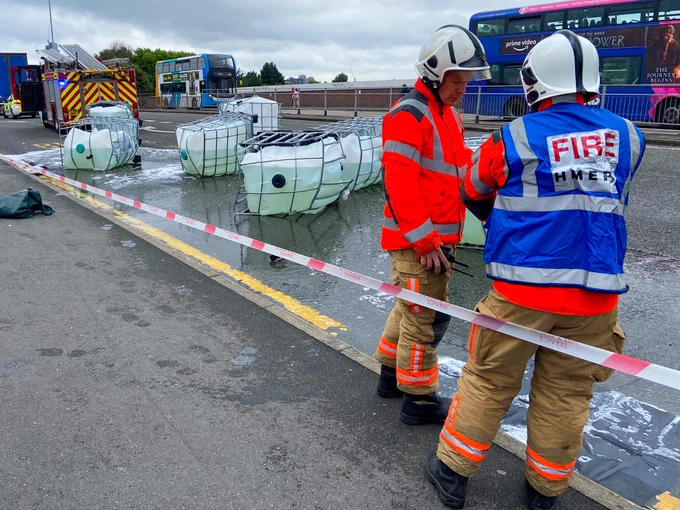 A Station Manager and HAZMAT Officer at the scene with spilt liquid on the roadway