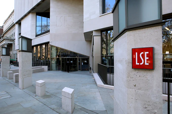The entrance to the Marshall Building on the LSE campus. The red LSE logo can be seen in the foreground.