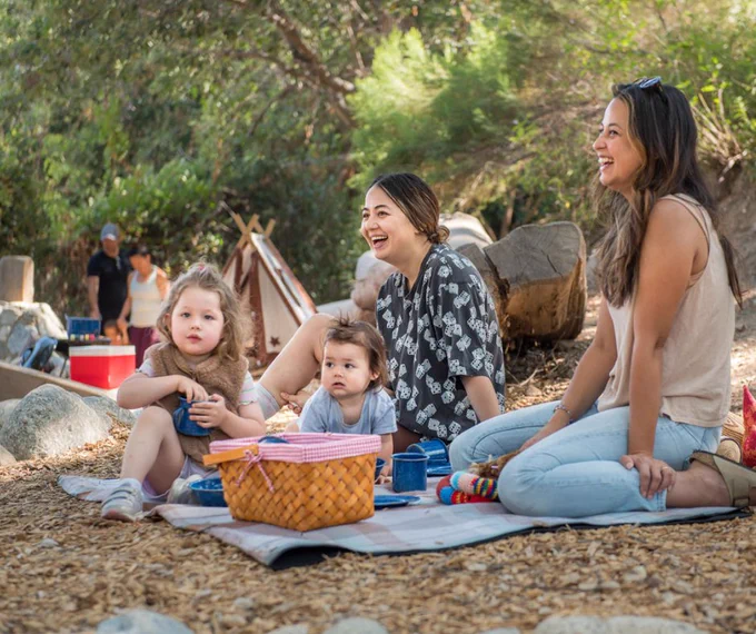 Moms and kids having a picnic