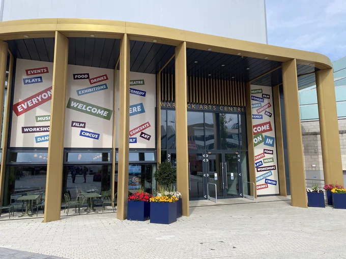 Main entrance to Warwick Arts Centre, large signs saying “everyone welcome here”