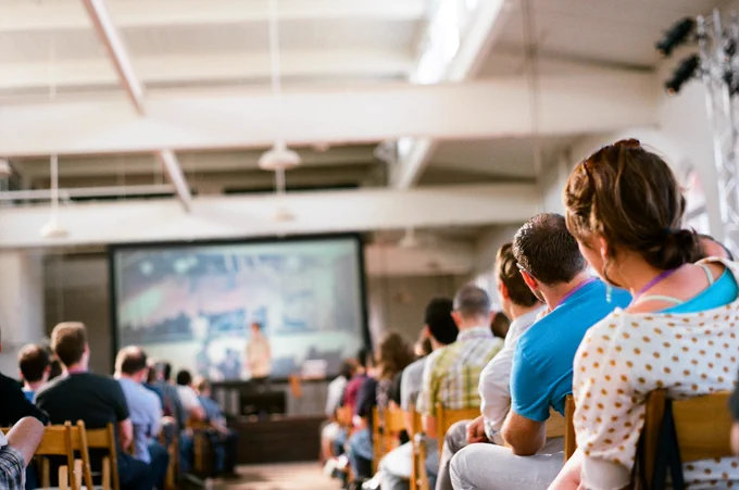 Photo from the back of the room of attendees watching the opening talk at the first XOXO
