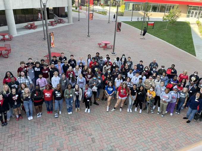JCPS students who participate in the University of Louisville’s Cardinal Bridge Academy stand outside on campus.