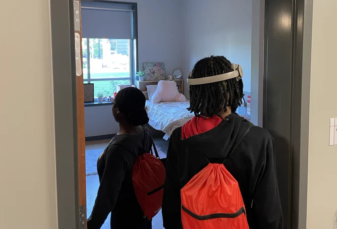 JCPS students look inside a University of Louisville dorm room.