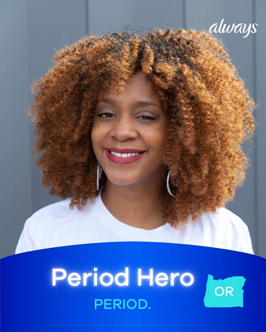 Image of a Black woman smiling, with a blue arch graphic on the lower half of the image reading, “Period Hero, PERIOD., OR.” 