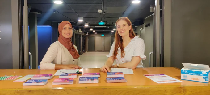 Nadia and Ella waiting for the participants at the registration desk.