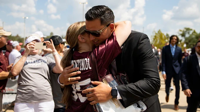 Nik Constantinou hugs his mother, Effie, as he arrives to Kyle Field on September 10, 2022.