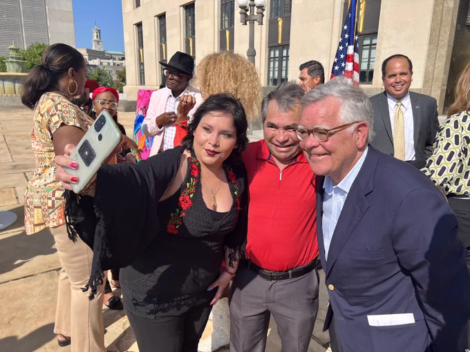 Mayor Cooper takes a photo with board member and attendee.