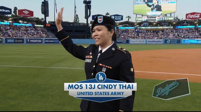 Cindy Thai in uniform waving at a Dodger Game. 