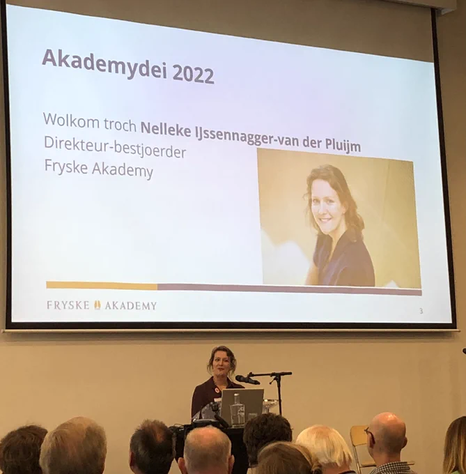 Nelleke on the podium giving a speech