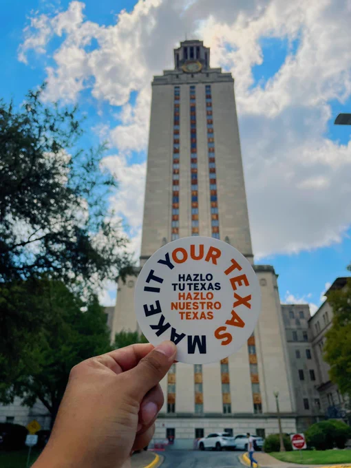 Pictured in front of the UT tower is a sticker celebrating Hispanic Heritage Month with the text saying “Make It Your Texas” in a circle while there are words in the middle saying “Halzo Tu Texas Halzo Nuestro Texas”