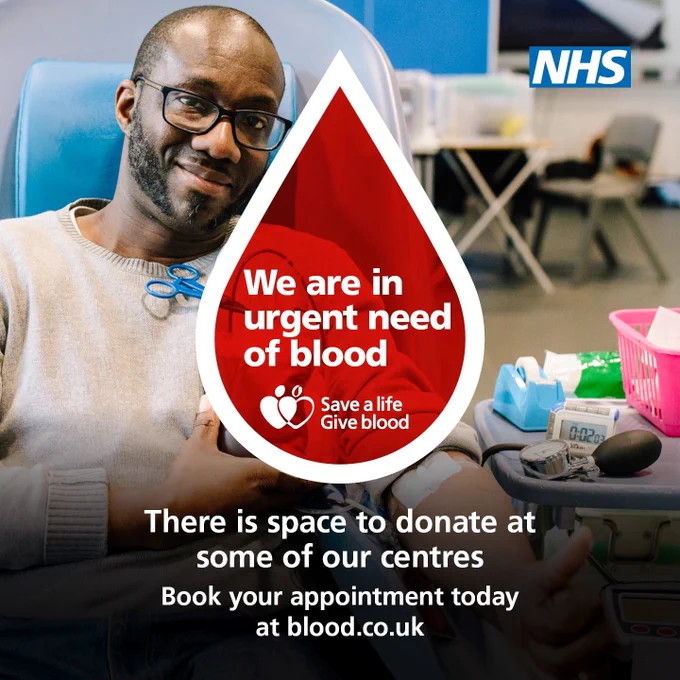A man is smiling as he gives blood. A graphic of a blood drop is on the photo. We are in urgent need of blood. There is space to donate at some of our centres. Book your appointment today at blood.co.uk.