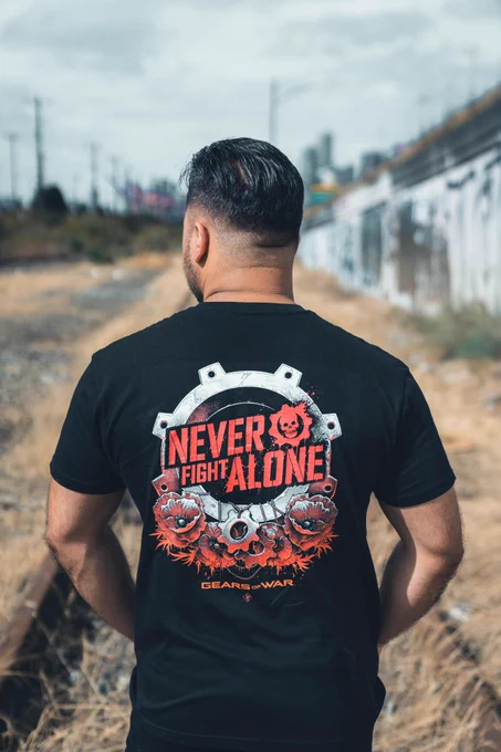 Person wearing the Never Fight Alone tee with the logo on the back. 
