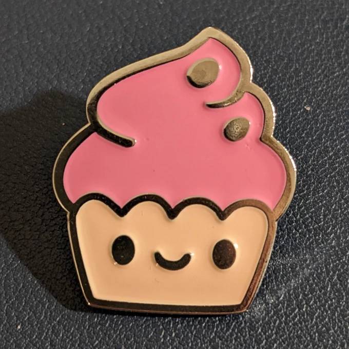 A tiny cute cupcake badge pin