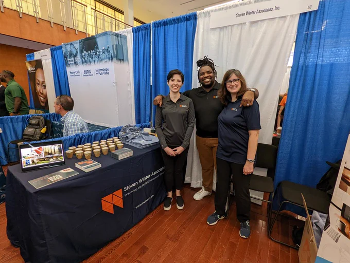 Three SWA employees at the Steven Winter Associates booth at the Howard University College of Engineering and Architecture Career Fair.