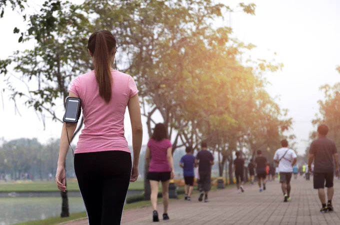 Group of people exercise walking in the park in morning