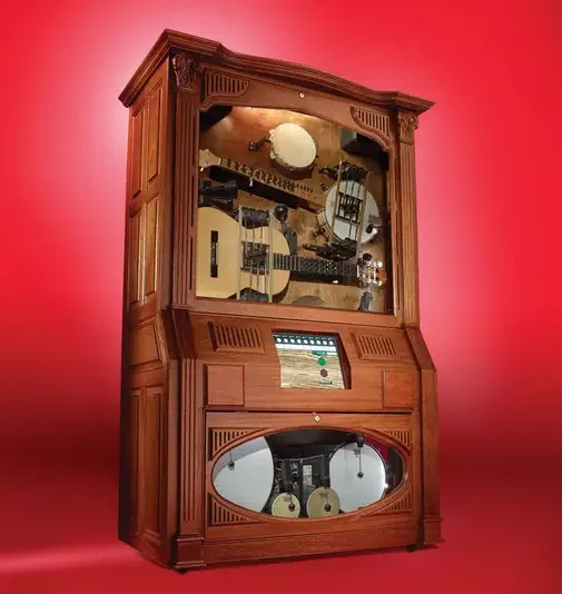 Hootenanny says it all here. It's a big wooden box with a large glass pane on the front, behind the pane is various instruments. This really is just some kind of contraption.