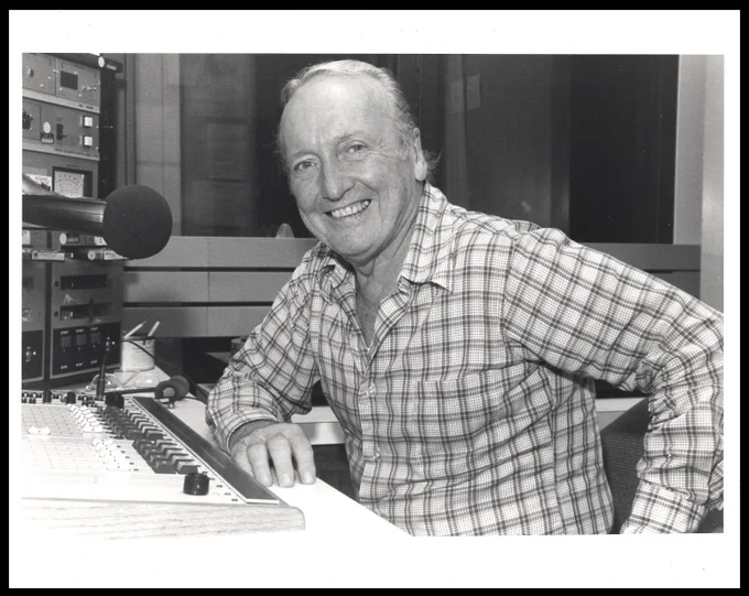 An older Grant sits at a desk in a radio station booth. He has an elbow on the table and gives a big smile to the camera. Source:  Felix E. Grant Jazz Archives,  University of the District of Columbia