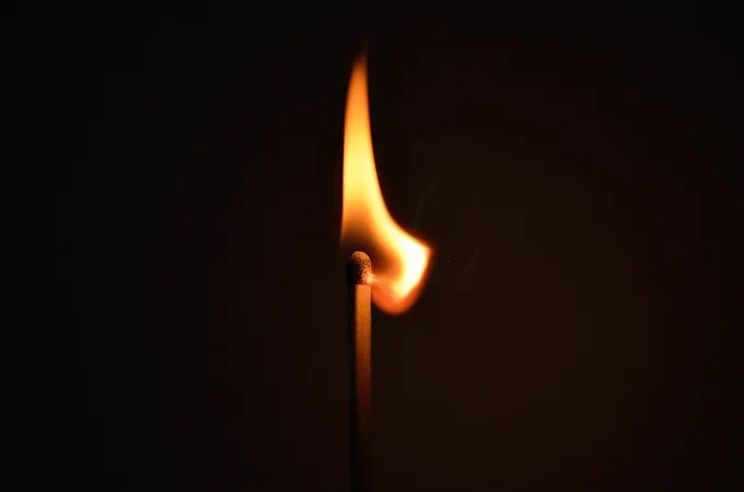 A lit match in the darkness.