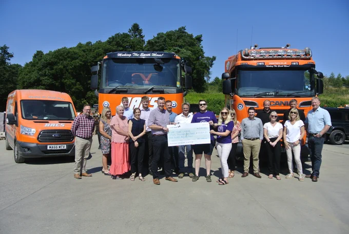 HACS Group staff presenting the Saint Michael’s Partnerships Team with a cheque following their 35-year anniversary fundraising efforts. 