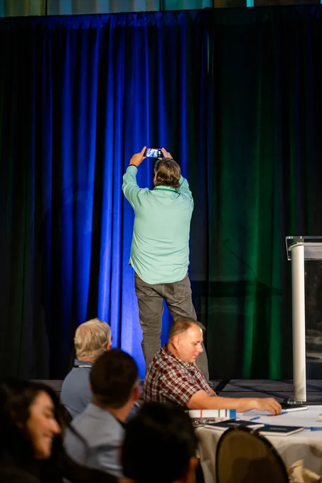 Tech Impact CEO Patrick Callihan takes a selfie from Tech Forward Conference's main stage.