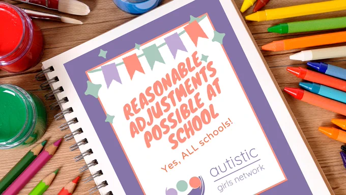 Top-down view of school desk covered in colouring pencils and paintbrushes. In the centre of the image is a document placed on the desk titled “Reasonable adjustments possible at school. Yes, all schools!” below the title is the logo of the Autistic Girls Network.