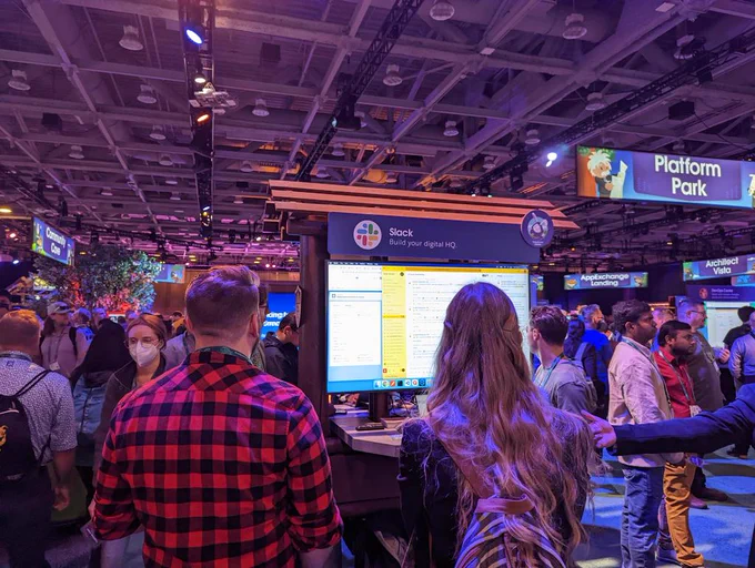 Event attendees watching a technical demo on a monitor 