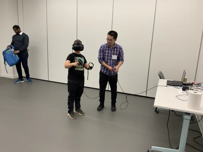 A child being helped by a man to look at the heart in Virtual Reality