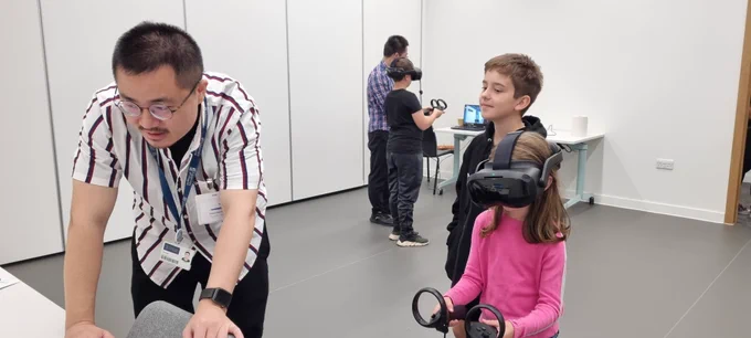 Two children in the Virtual Reality (VR) suite being shown how to look at the heart in VR