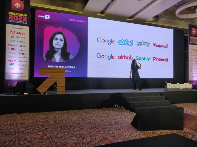 Meeta with a slide that shows many popular brand logos redesigned to look the same