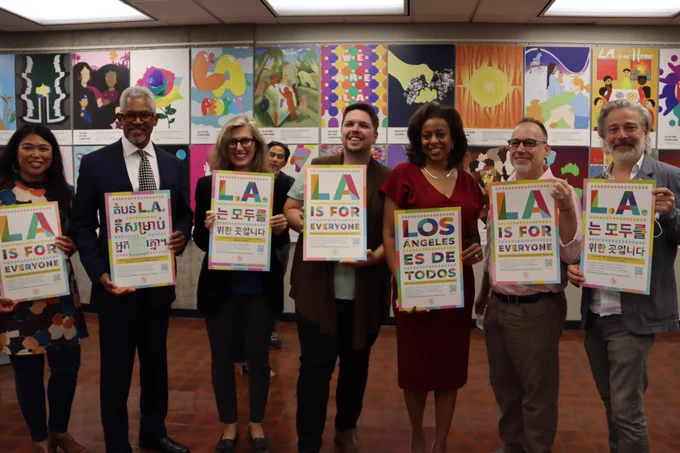 Professor Vernon with LA City representatives and Dean Trzaskoma and Associate Dean Weiss holding official multi-language LA For All posters.