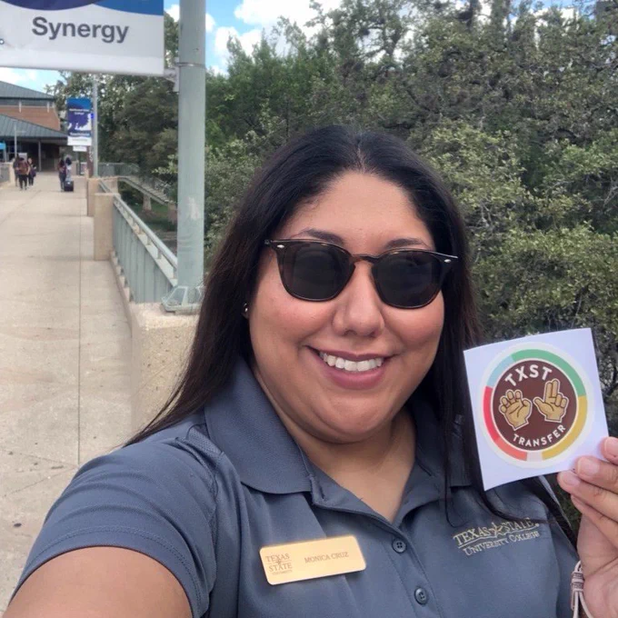 Student Development Specialist, Monica Cruz, holding a new Texas State Transfer Sticker at Alamo Colleges District.