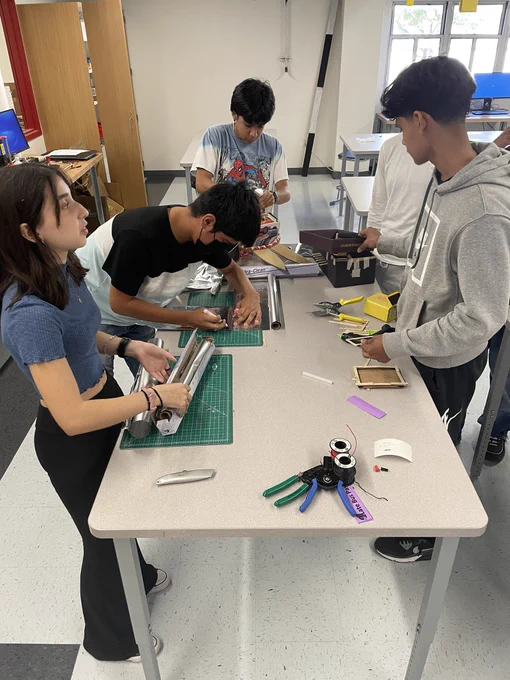 Students work to on their pin hole cameras.