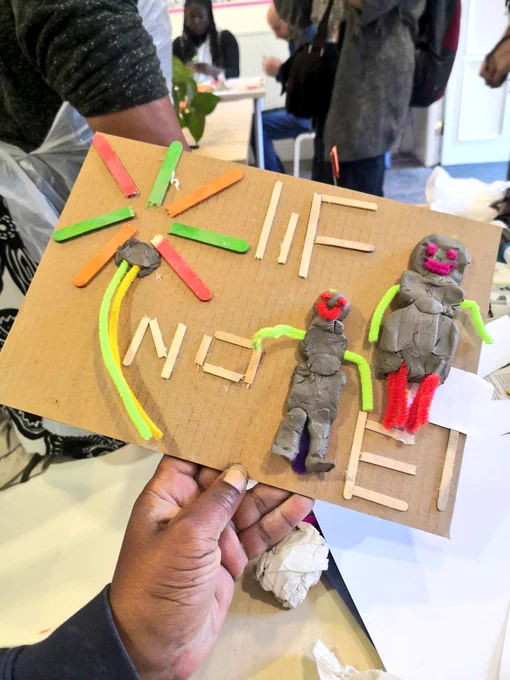 a cardboard artwork with recycled materials