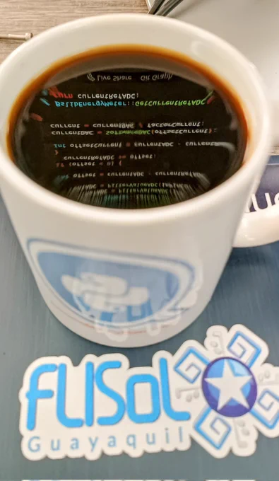a cup of coffee reflecting a screen with lines of code