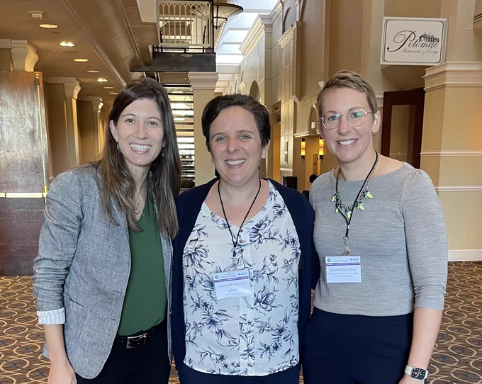 Alexandra Coso Strong, Kaitlin Mallouk, Courtney Faber standing together at a conference.