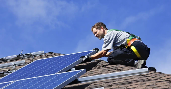 This is a photograph of the installation of solar panels on a home's roof.