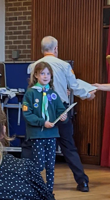 Cub Scout receiving a certificate 