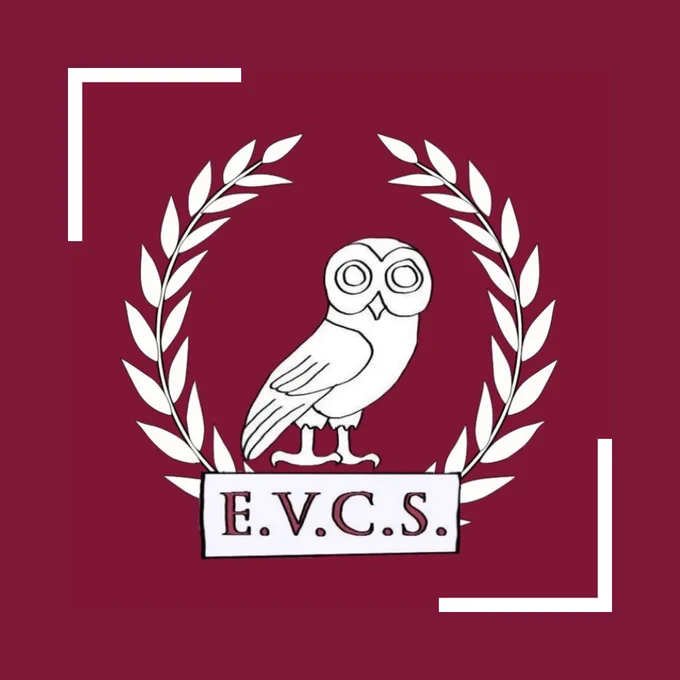 [image: the Edinburgh University Classics Society logo. A cartoon owl in between a laurel wreath is shown in white against a red background. At the owl’s feet there is a white banner reading E.V.C.S written in red. There are two white lines on opposite sides of the image, forming white corners against the red background.]
