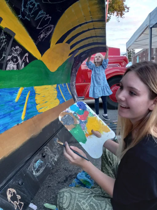 Jada Heren painting the City of Grandview snow plow