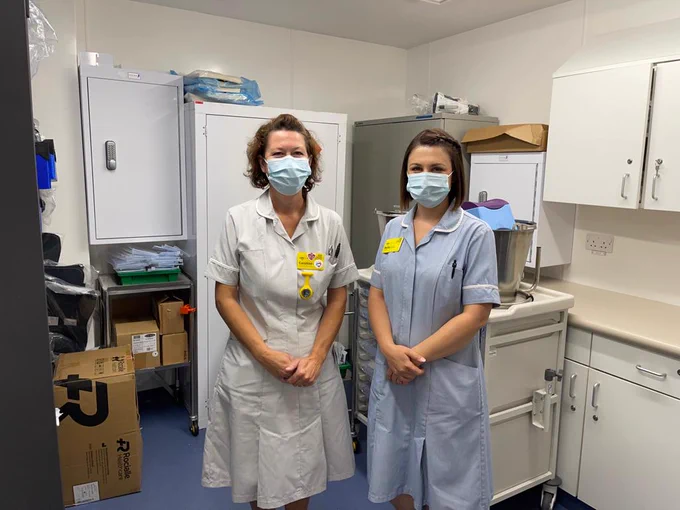 Image of Becky and Caroline standing in the stockroom