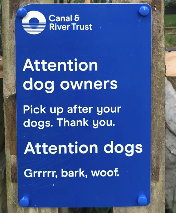 Attention dog owners: Pick up after your dogs. Thank you. Attention dogs: Grrrrr, bark, woof