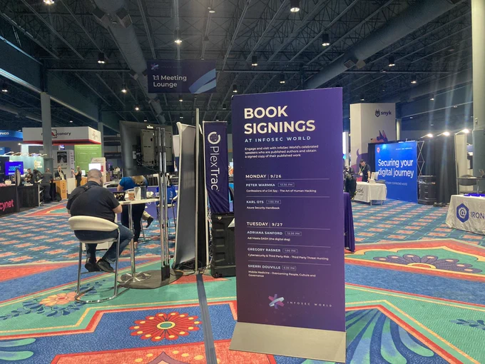 Sign at the InfoswcWorld event, directing to book signings