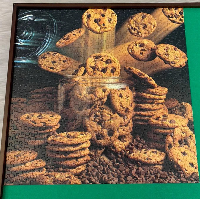 Puzzle of chocolate chip cookies exploding out of a Cookie Jar