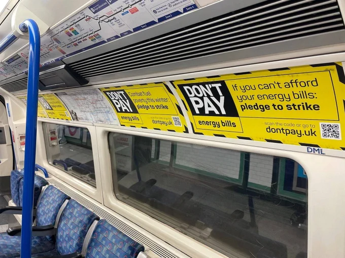 4 Posters installed above seats inside London tube.  Posters read: "don't pay. If you can't afford your energy bills: pledge to strike."