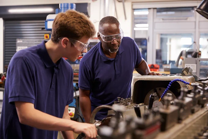 Two members of staff working in a factory