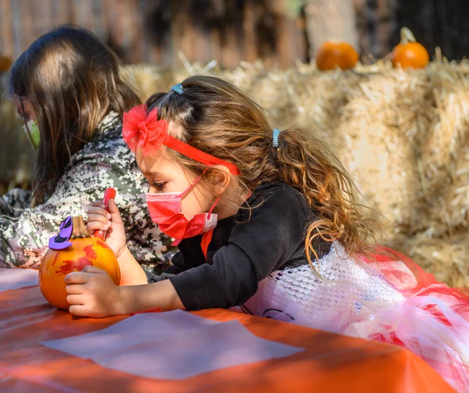 Child decorating pumpkin