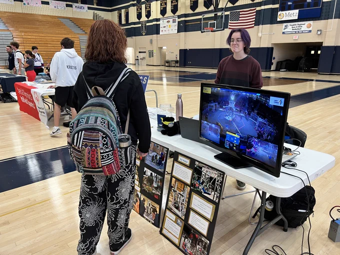 Rory Messersmith talks to her classmates about the hands-on FRobotics workshop at the Newlonsburg Administrative Center and shows video clips of the team’s competitions. 


