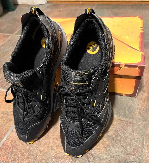 Jurassic World Reeboks in front of the mosquito-in-amber box.