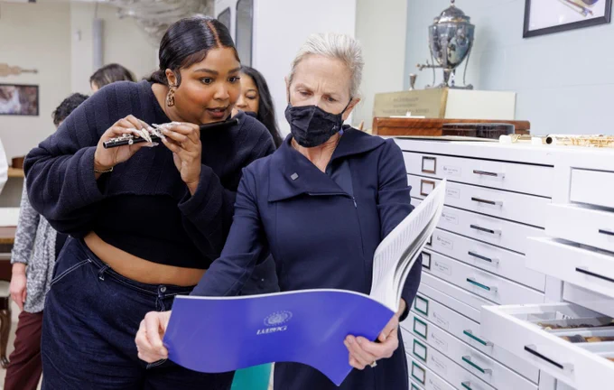 Lizzo checks the sheet music while playing one of the LIbrary’s flutes. Photo: Shawn Miller.
